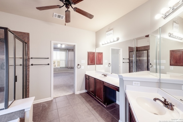 bathroom featuring tile patterned flooring, ceiling fan, a shower with door, and vanity