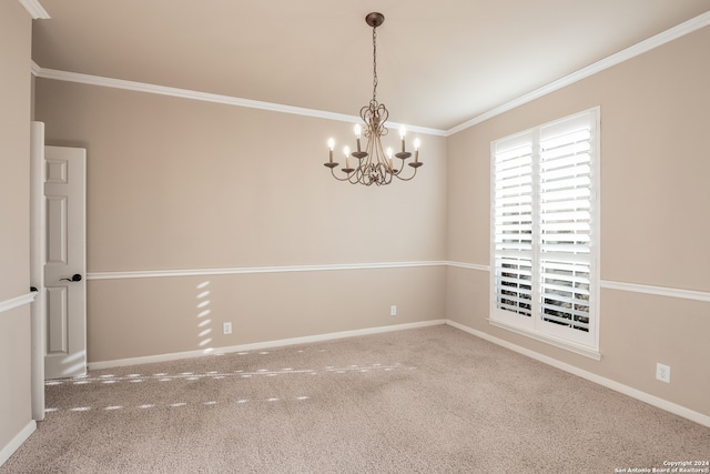 carpeted spare room featuring crown molding and a notable chandelier