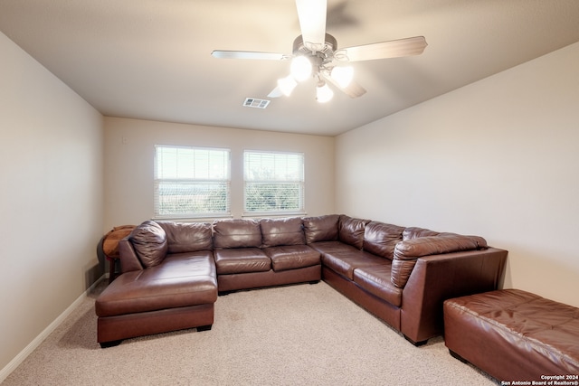 carpeted living room with ceiling fan