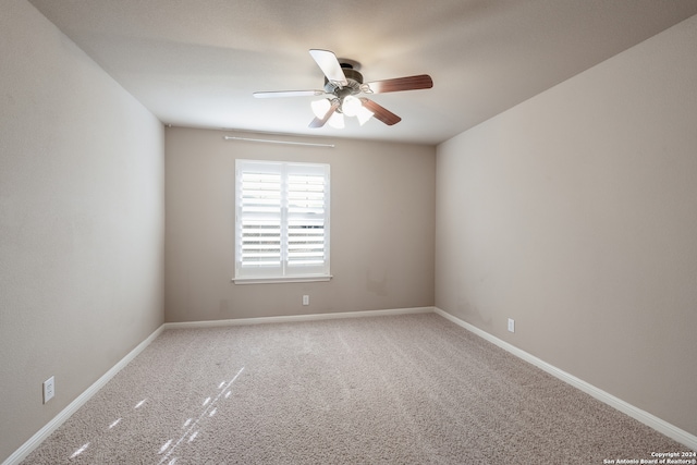 carpeted spare room with ceiling fan