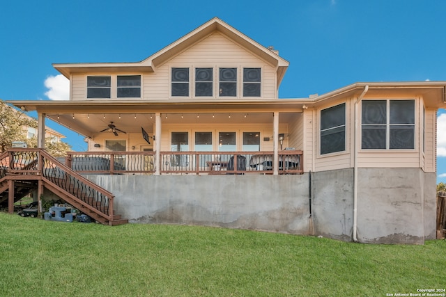 back of property featuring ceiling fan and a lawn