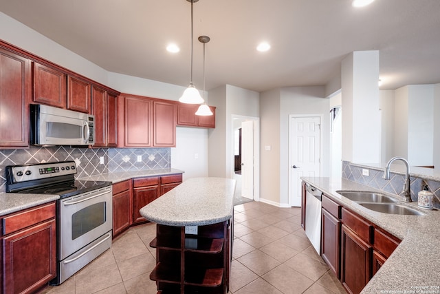 kitchen with pendant lighting, light tile patterned floors, sink, stainless steel appliances, and decorative backsplash