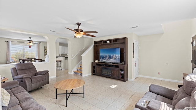 living room with ceiling fan and light tile patterned floors