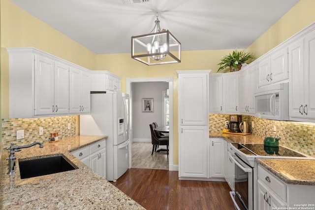 kitchen featuring white cabinets, white appliances, decorative light fixtures, dark hardwood / wood-style floors, and sink