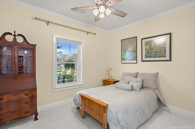 bedroom featuring ceiling fan, light colored carpet, and crown molding