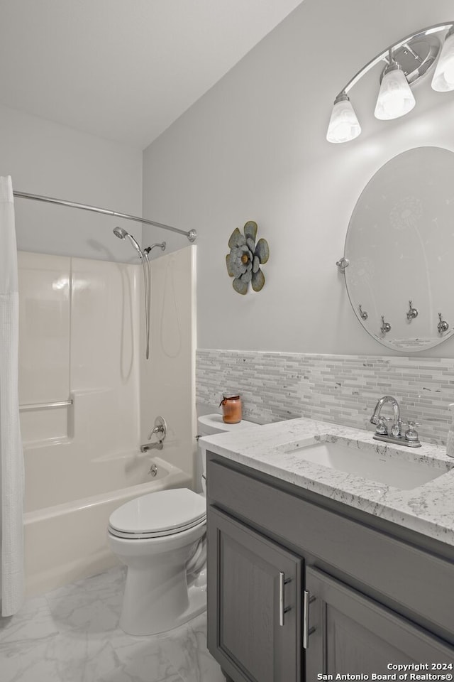 full bathroom with tile walls, shower / tub combo with curtain, vanity, and toilet