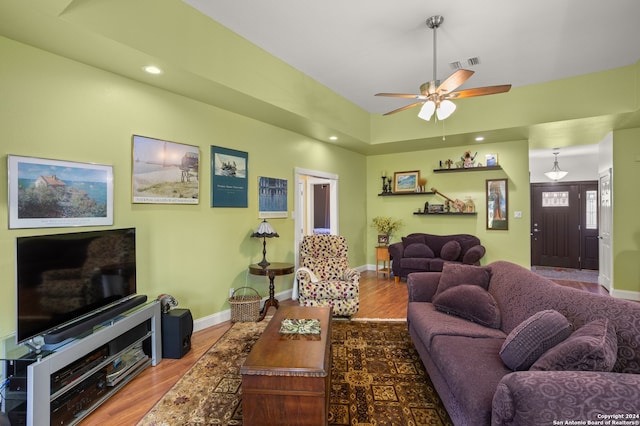 living room featuring ceiling fan and hardwood / wood-style flooring