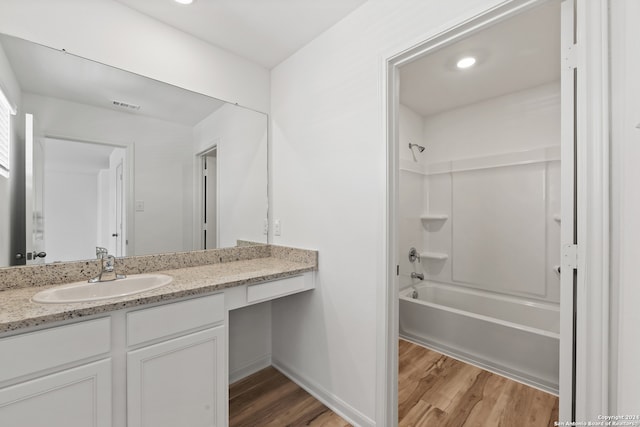 bathroom with vanity, shower / bath combination, and hardwood / wood-style flooring