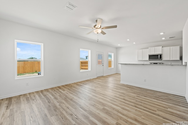 unfurnished living room with light wood-type flooring and ceiling fan