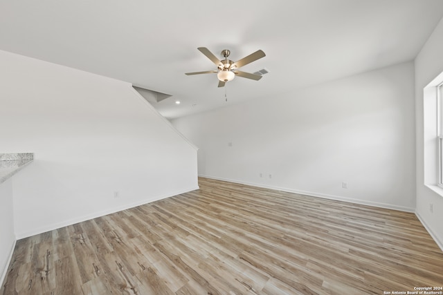 unfurnished room with ceiling fan and light wood-type flooring