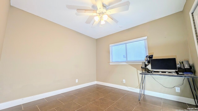 office area with ceiling fan, vaulted ceiling, and tile patterned floors