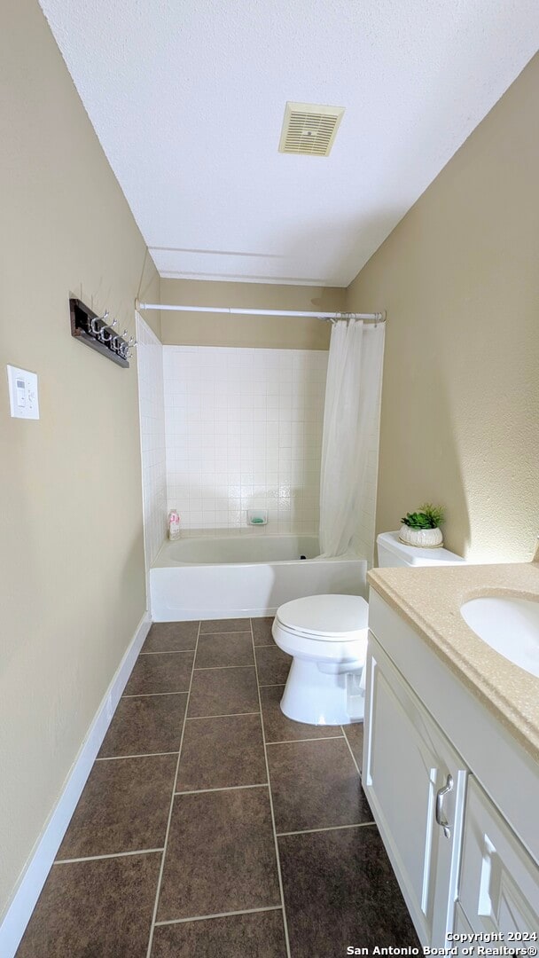 full bathroom with vanity, toilet, tile patterned floors, and shower / bath combination with curtain