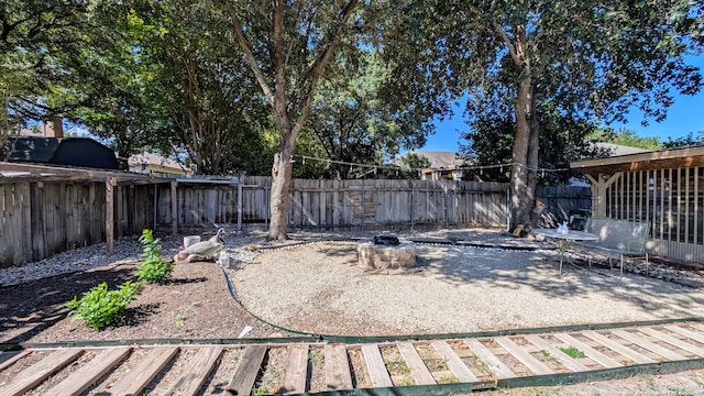 view of yard featuring an outdoor fire pit