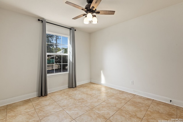 tiled empty room with ceiling fan