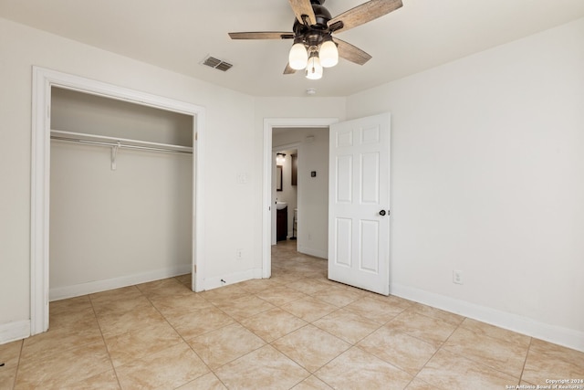 unfurnished bedroom with ceiling fan, a closet, and light tile patterned floors