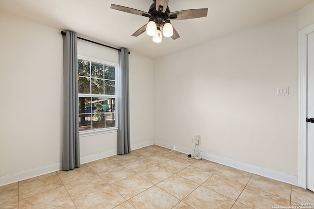 tiled empty room with ceiling fan