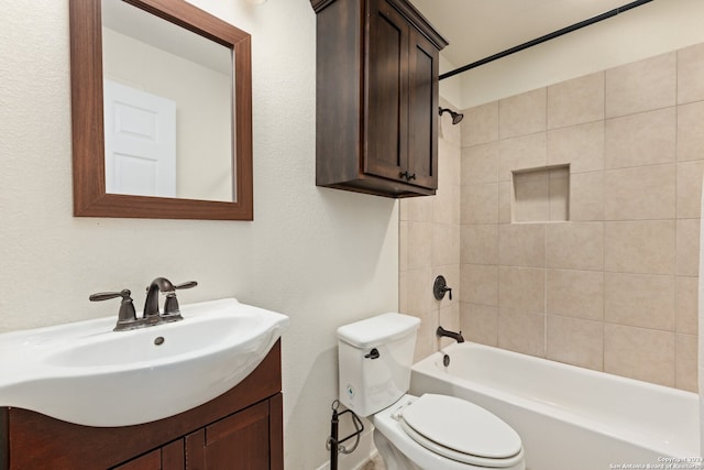 full bathroom featuring toilet, vanity, and tiled shower / bath