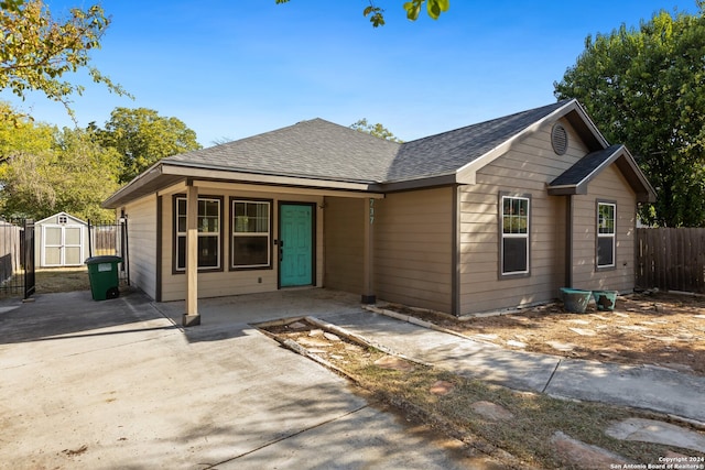 bungalow-style house featuring a shed and a patio area