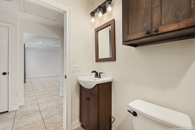 bathroom with toilet, tile patterned flooring, and vanity