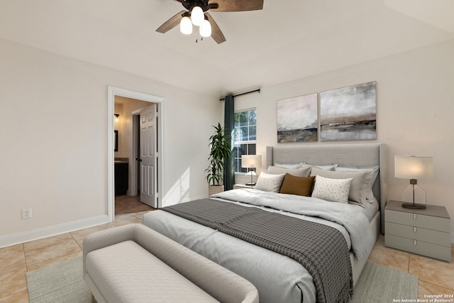 bedroom with light tile patterned flooring, ceiling fan, and ensuite bath