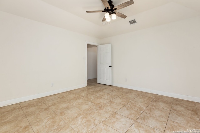 tiled empty room featuring ceiling fan