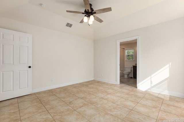 tiled empty room featuring ceiling fan