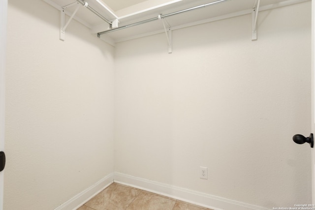 walk in closet featuring tile patterned flooring