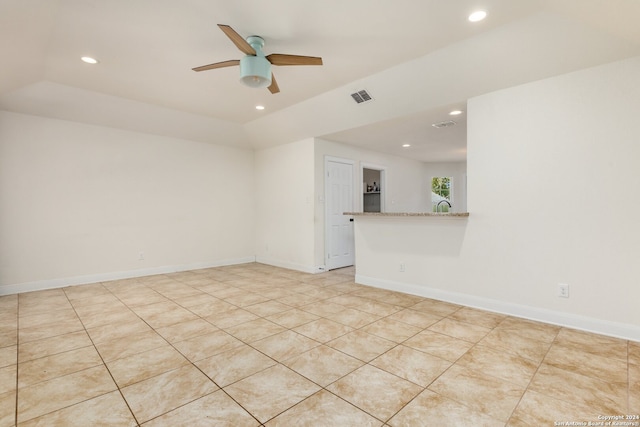 tiled empty room with ceiling fan