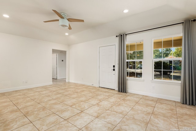 tiled empty room with ceiling fan