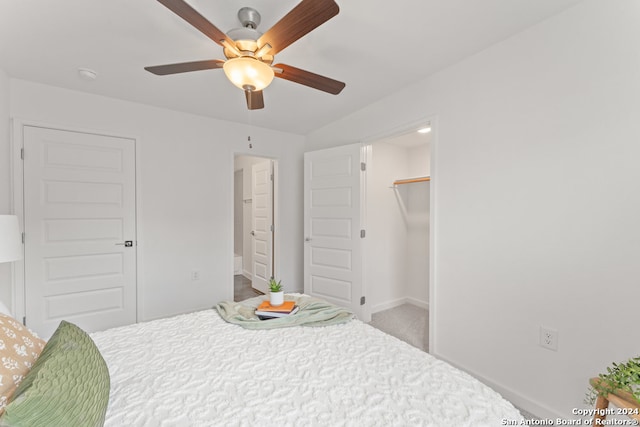 carpeted bedroom with ceiling fan and a closet