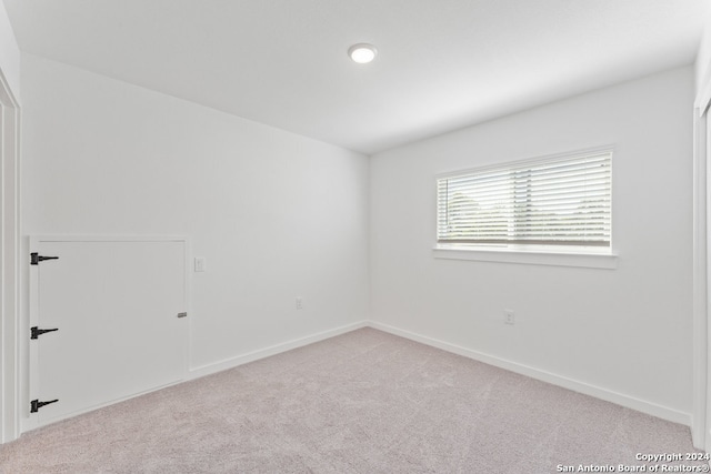 empty room featuring light colored carpet