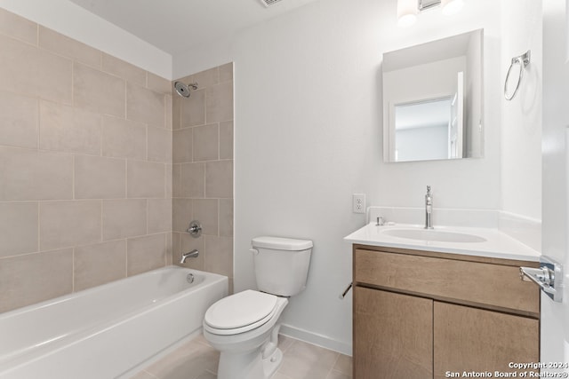 full bathroom with tiled shower / bath, vanity, tile patterned flooring, and toilet