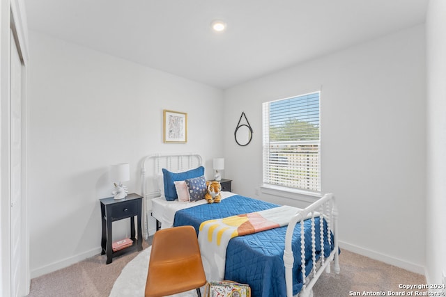 bedroom featuring light carpet