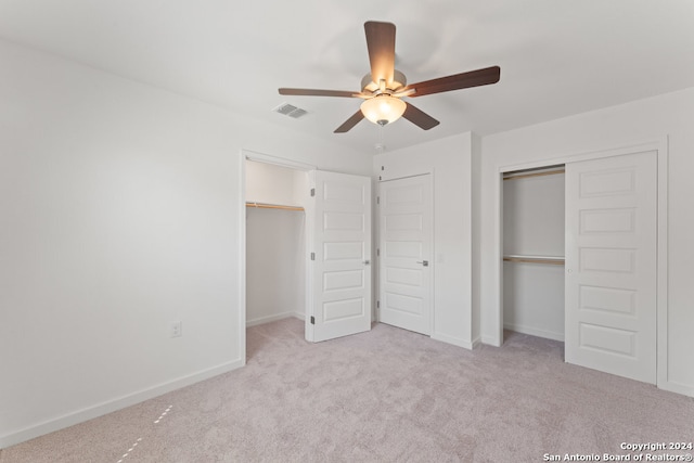 unfurnished bedroom featuring light carpet and ceiling fan