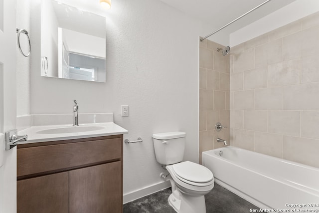 full bathroom with tiled shower / bath, vanity, and toilet