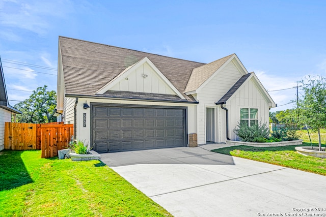 view of front of house featuring a garage and a front lawn