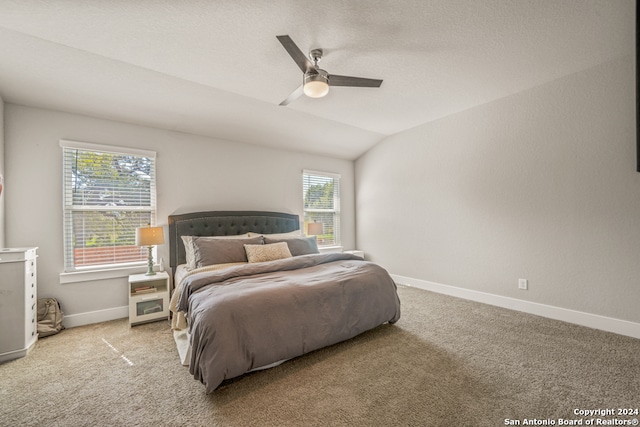 bedroom featuring vaulted ceiling, ceiling fan, and light colored carpet