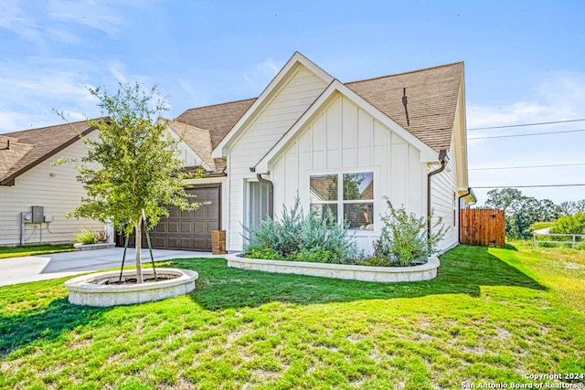 view of front of property with a front lawn and a garage