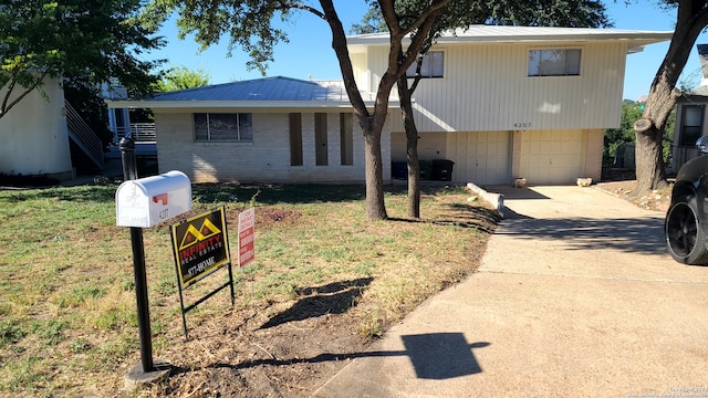 view of front of house featuring a garage and a front lawn