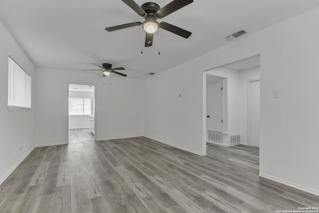 4207 High Sierra, San Antonio, TX 78228 - unfurnished living room featuring a ceiling fan, wood finished floors, and baseboards