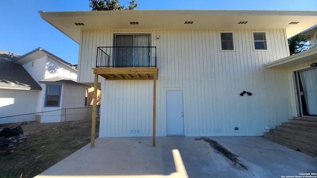 rear view of property with a balcony