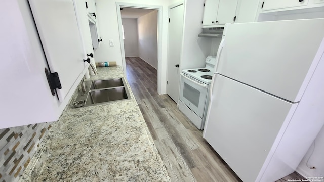 kitchen with white appliances, sink, light hardwood / wood-style flooring, and white cabinetry