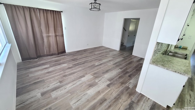 unfurnished dining area featuring sink and light wood-type flooring