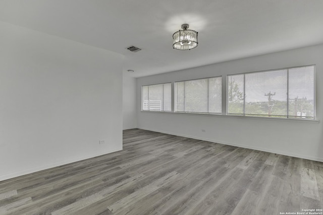 4207 High Sierra, San Antonio, TX 78228 - spare room featuring wood finished floors, a chandelier, and baseboards