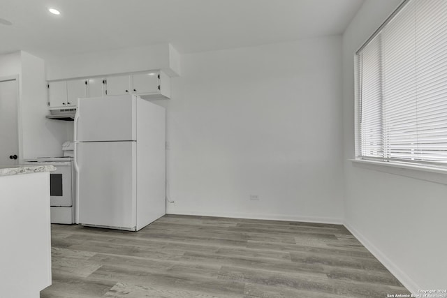 4207 High Sierra, San Antonio, TX 78228 - kitchen with white appliances, under cabinet range hood, white cabinets, light countertops, and light wood finished floors