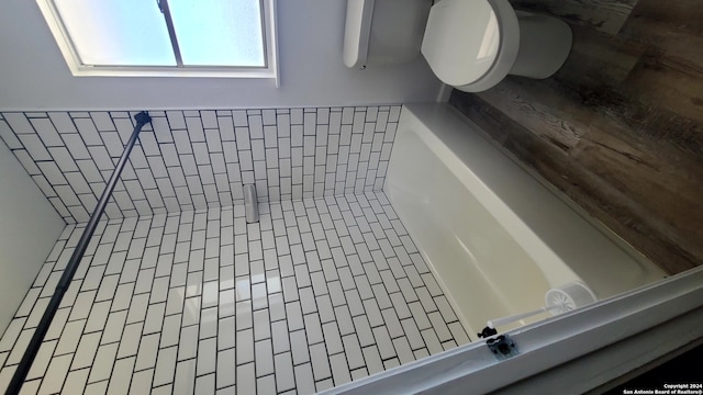 bathroom with tile patterned flooring, toilet, and plus walk in shower