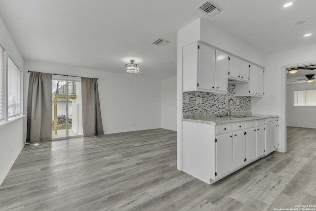 4207 High Sierra, San Antonio, TX 78228 - kitchen featuring a sink, light wood-style flooring, tasteful backsplash, healthy amount of natural light, and recessed lighting