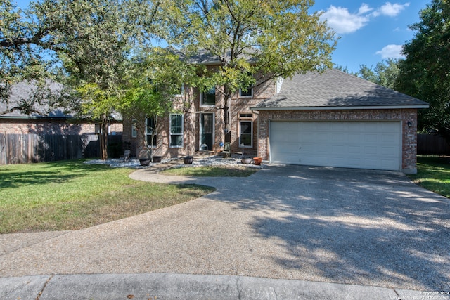 view of front of home with a garage and a front lawn