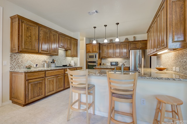 kitchen with a kitchen breakfast bar, stainless steel appliances, and backsplash