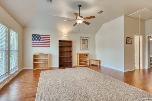 unfurnished living room with lofted ceiling, ceiling fan, and dark hardwood / wood-style flooring